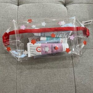 First Aid Beauty Clear Cosmetic Bag with Red Stars